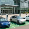 Retail EV charging strategy: EV charging bays at a shopping mall entrance with green-plate electric cars parked near the storefront