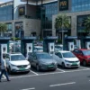 EV charging data-driven site selection — a busy commercial parking lot with chargers actively in use