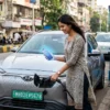 EV driver onboarding app journey — first-time owner charging at a public station in India with a green EV number plate