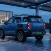 Electric SUV charging at a covered DC fast-charging forecourt, illustrating OEM charging partnerships between vehicle manufacturers and charge point operators