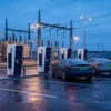 EV fast-charging hub beside a grid substation illustrating wheeling charges and open access power for EV charging in India