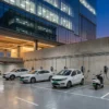 EV charging bays with wall-mounted chargers in a commercial building's podium car park, the provision green building certification and India's building codes require