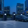 EV charging for real estate — charging bays in a commercial office park podium car park with green-number-plate electric cars