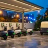 Two wheeler EV charging station with electric scooters and e-rickshaws plugged into LEV AC points at an Indian urban charging bay